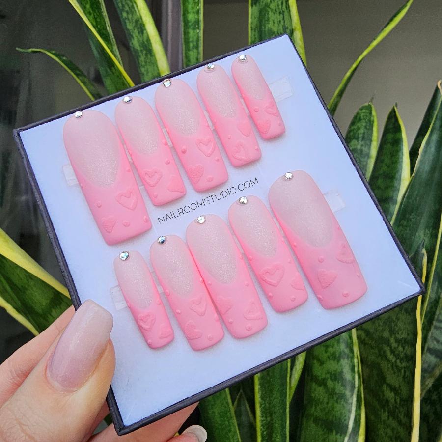 Dreamy long pink press-on nails with a jelly finish, showcasing a blend of rainbow colors at the tips and elegant 3D golden accents, perfect for special occasions or everyday wear