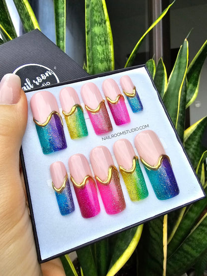 Beautiful long pink nail bed, square press-on nails with a sparkling glittery jelly finish, featuring rainbow-colored tips and stunning 3D golden lines, perfect for adding a pop of color to any outfit