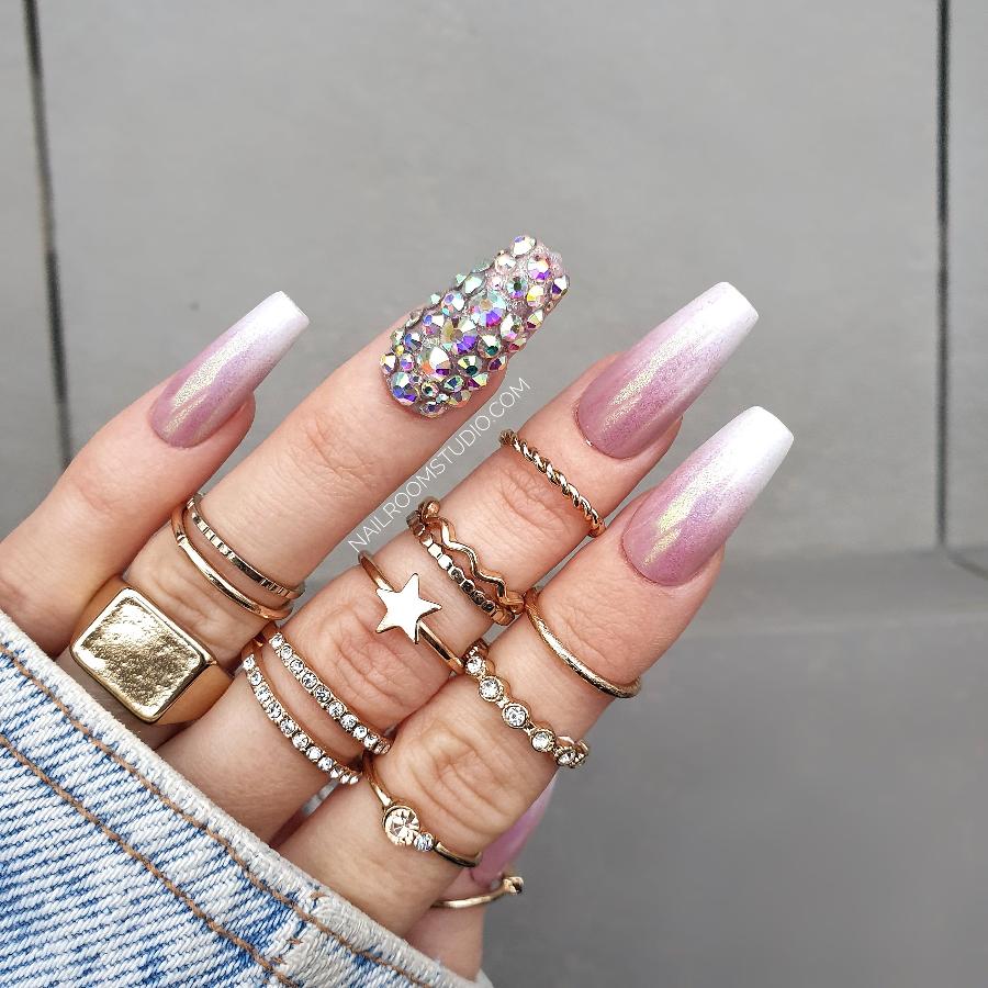 Stylish baby boomer nails adorned with crystal embellishments, offering a luxurious finish