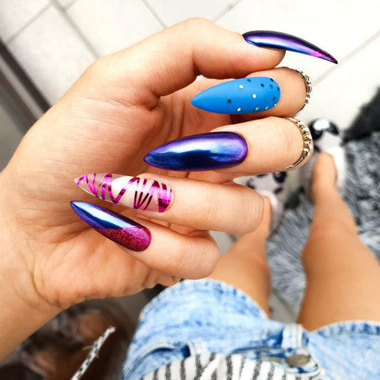 Bold matte navy blue stiletto nails with pink chrome striping and a touch of blue glitter