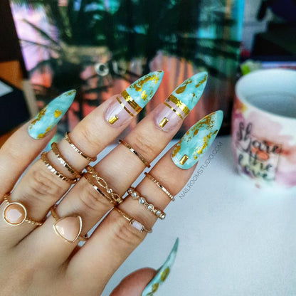 Stylish mint and baby blue nails with golden chrome stripes, inspired by ethnic and Amazonian designs