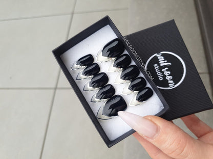 Exclusive black press-on nails featuring a chrome French design with silver and transparent clear space in the French frame. Standard length in a stiletto shape, original and handmade