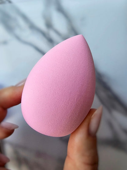 Flawless foundation sponge in pink, perfect for dampening and applying makeup for a radiant, airbrushed finish