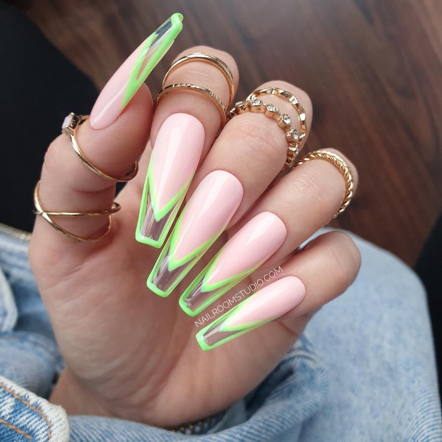 French nails in soft pink nail bed with neon green tips and a clear modern framed french design, presented with jewelry on fingers