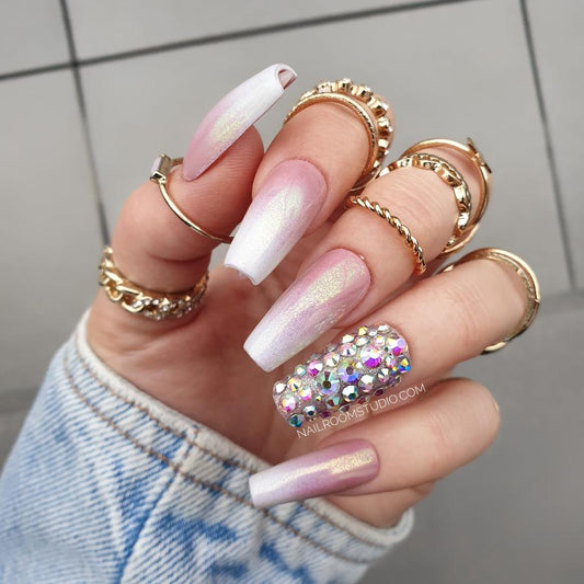 Glamorous baby boomer nails with gem accents, perfect for a chic and trendy look