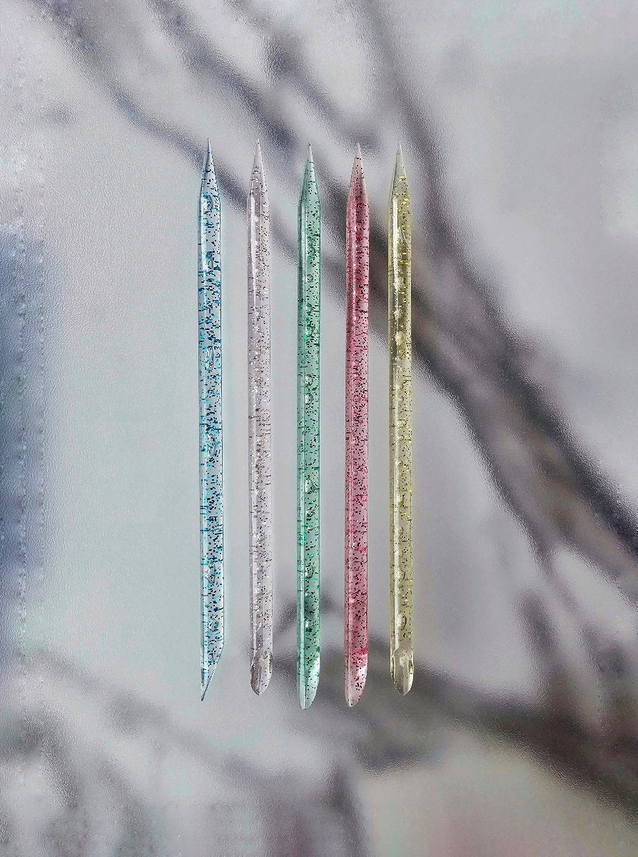 Glittery colorful cuticle pushers available in multiple colors, perfect for adding a touch of sparkle to your nail care routine