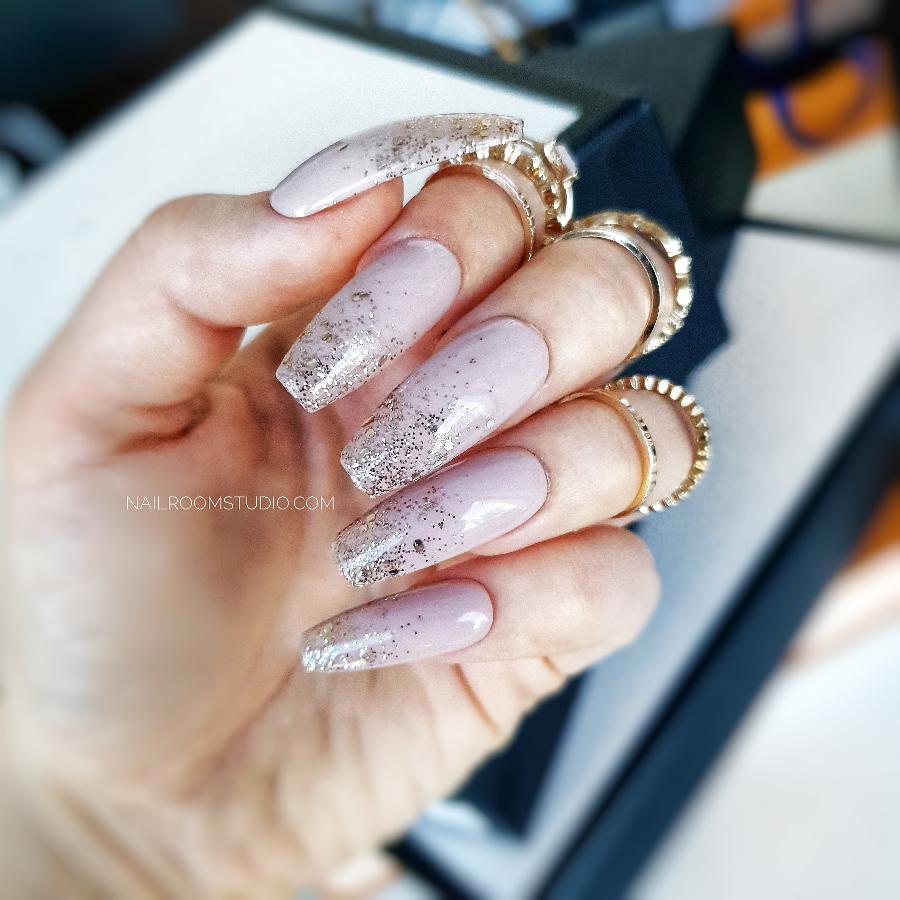 Long nude ballerina nails with a soft glitter ombre and chrome-like sparkle, a delicate bridal style