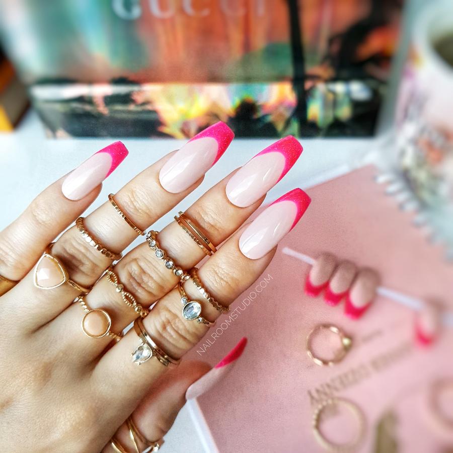 Charming French manicure featuring glittery pink and bold intense pink tips for an elegant yet playful design