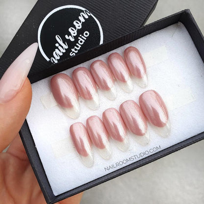 Glossy, glazed peach-beige-pink press-on nails in French style featuring a fancy transparent tip. Standard length almond shape, made from natural acrylic nails, available in all sizes with international shipping