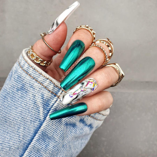 Shiny green chrome nails with black and white marble accents and original Swarovski crystals, featured as Press-On nails with a stylish finish