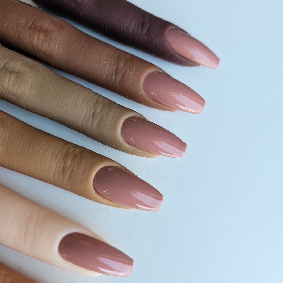 Light brown press-on nails with a cappuccino tone, a universally flattering shade for all skin tones, artificial tips for toes and fingers