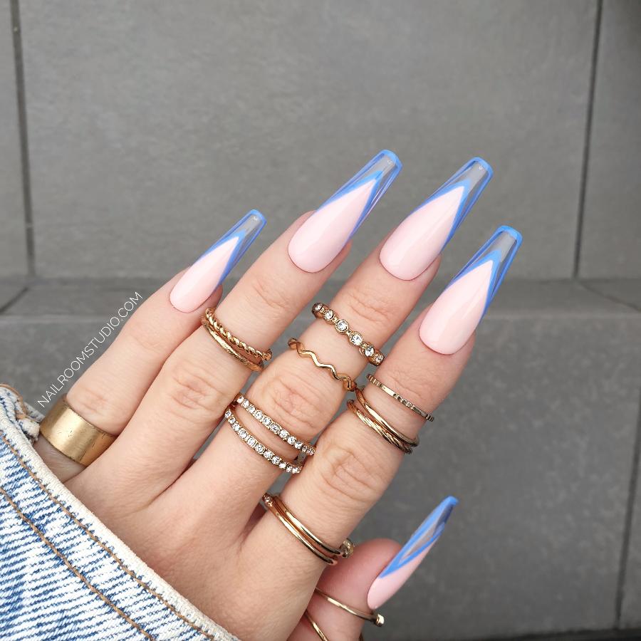 Lilac and baby blue French nails with a transparent modern style, displayed on a hand adorned with gold rings