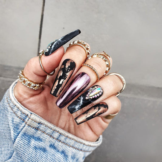 Sculpted coffin faux nails in matte black finish featuring rich rust chrome and hand-painted black marble details, adorned with Swarovski crystals