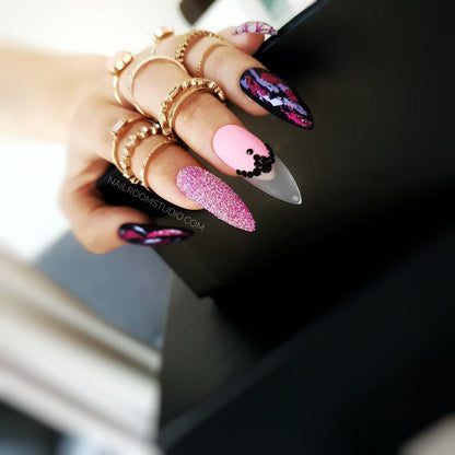 Long stiletto nails in shades of pink and purple with a stunning chrome finish that reflects light beautifully