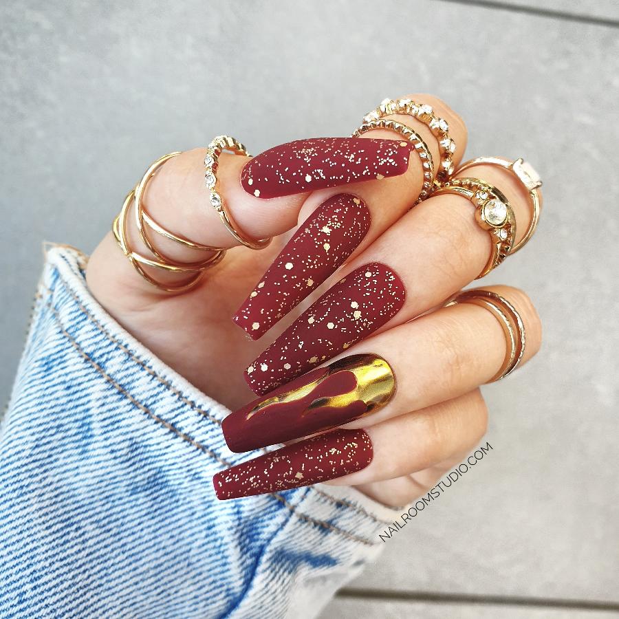 Ultraexclusive deep burgundy matte color coffin nails with matte gold glitter and gold chrome flames, bold and sophisticated, available in custom shapes and lengths, with toe tips included by Nail Room Studio