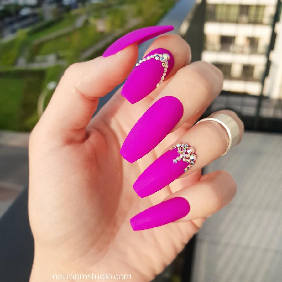 Bold matte neon purple press-on nails enhanced with opalescent Swarovski crystal details in a captivating design. Available in various lengths and sizes, with shipping to the USA