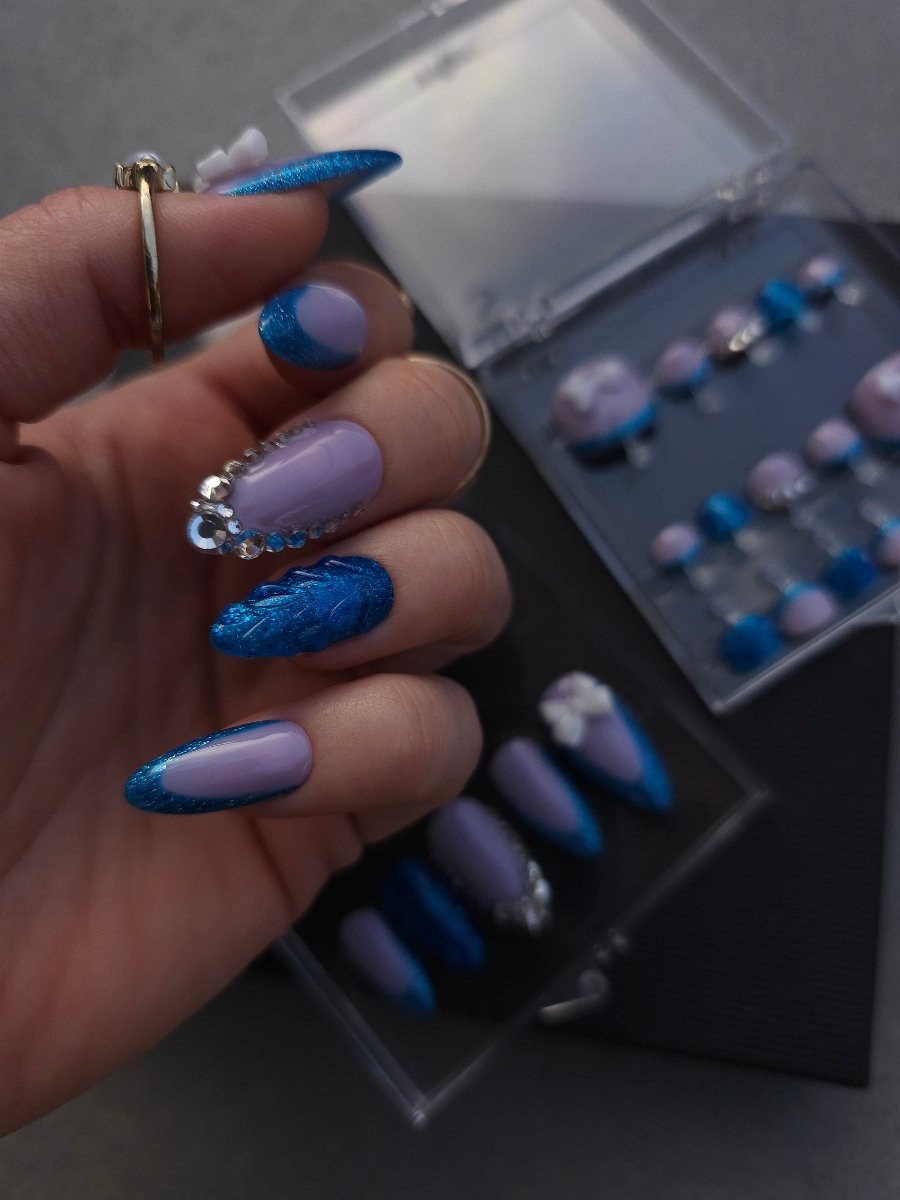 Blue shell press on nails with mauve French tips, Swarovski crystals, and silver bow accents, available in custom lengths and shapes, worldwide shipping, blue glitter, glossy.