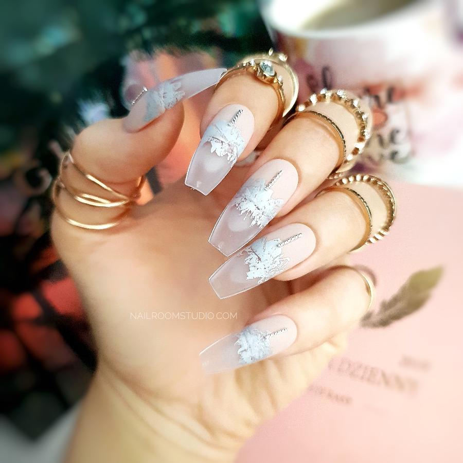 Matte nude nails with a natural hue, accented with silver and a frozen-inspired transparent modern French tip