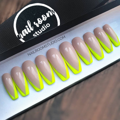 Chic coffin press on nails showcasing a nude base and vibrant neon yellow French tips, designed for a contemporary and bright appearance