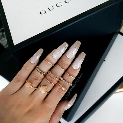 Nude coffin nails with a gold glitter ombre, ideal for weddings or a girly, soft look