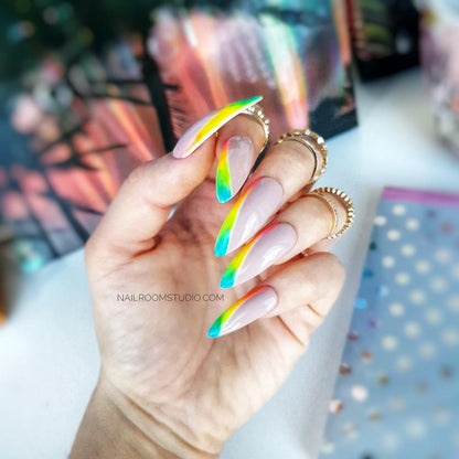 Subtle nude nails accented by a diagonal rainbow French tip in vivid colors such as yellow green pink orange and red perfect for a lively and stylish appearance