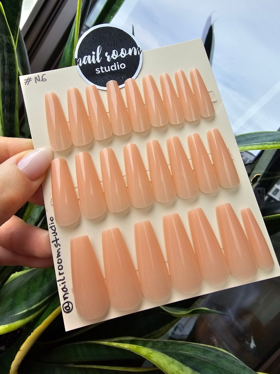 Peach-colored ready-to-wear instant nails, part of a new collection, offering quick and effortless application for a chic look