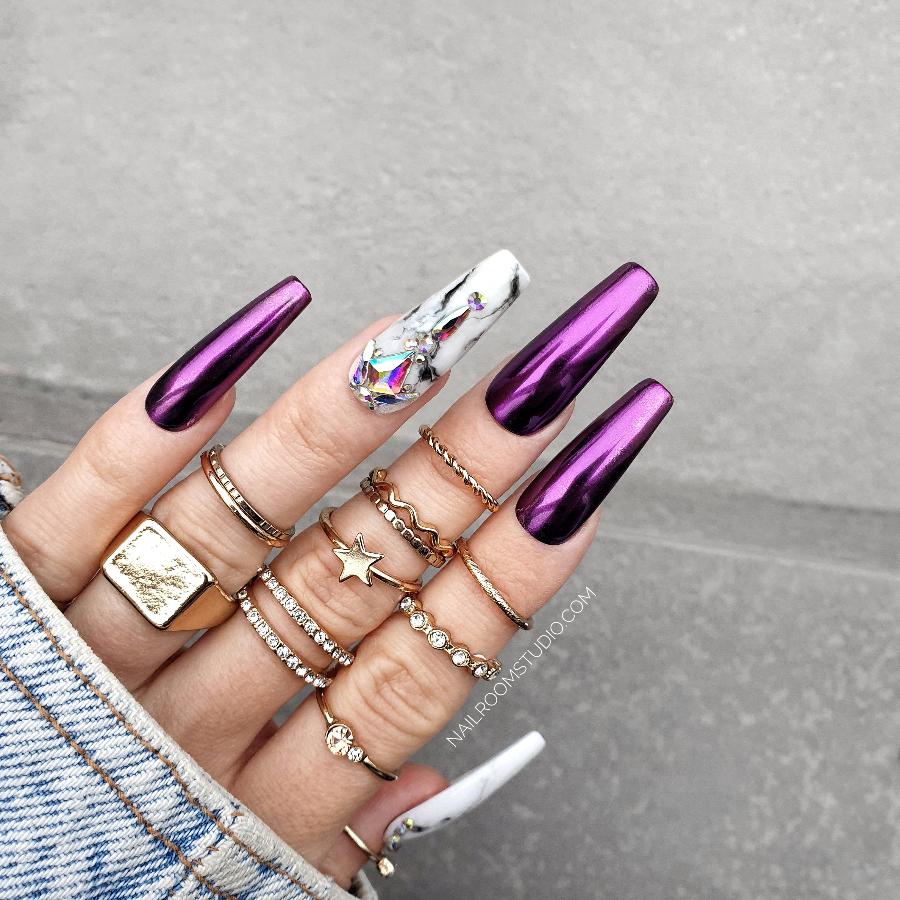 Elegant pink and purple chrome nails with marble accents and AB Swarovski crystals, showcased on a hand with stylish, long coffin nails