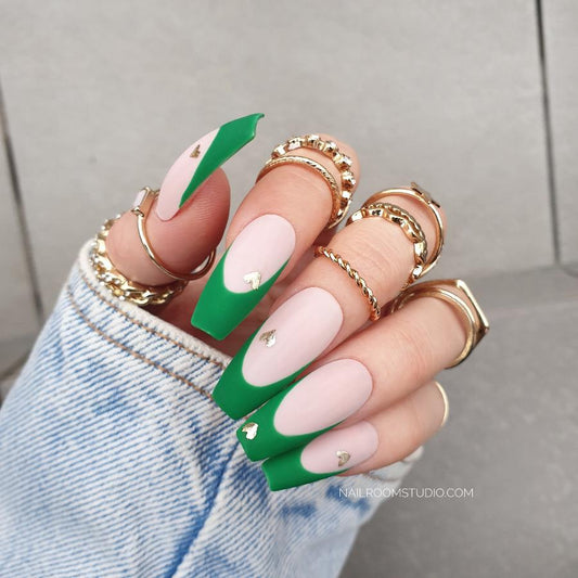 Subtle pink matte nails with hand-painted green French tips and adorable silver chrome heart accents, ideal for Valentine’s Day and special dates