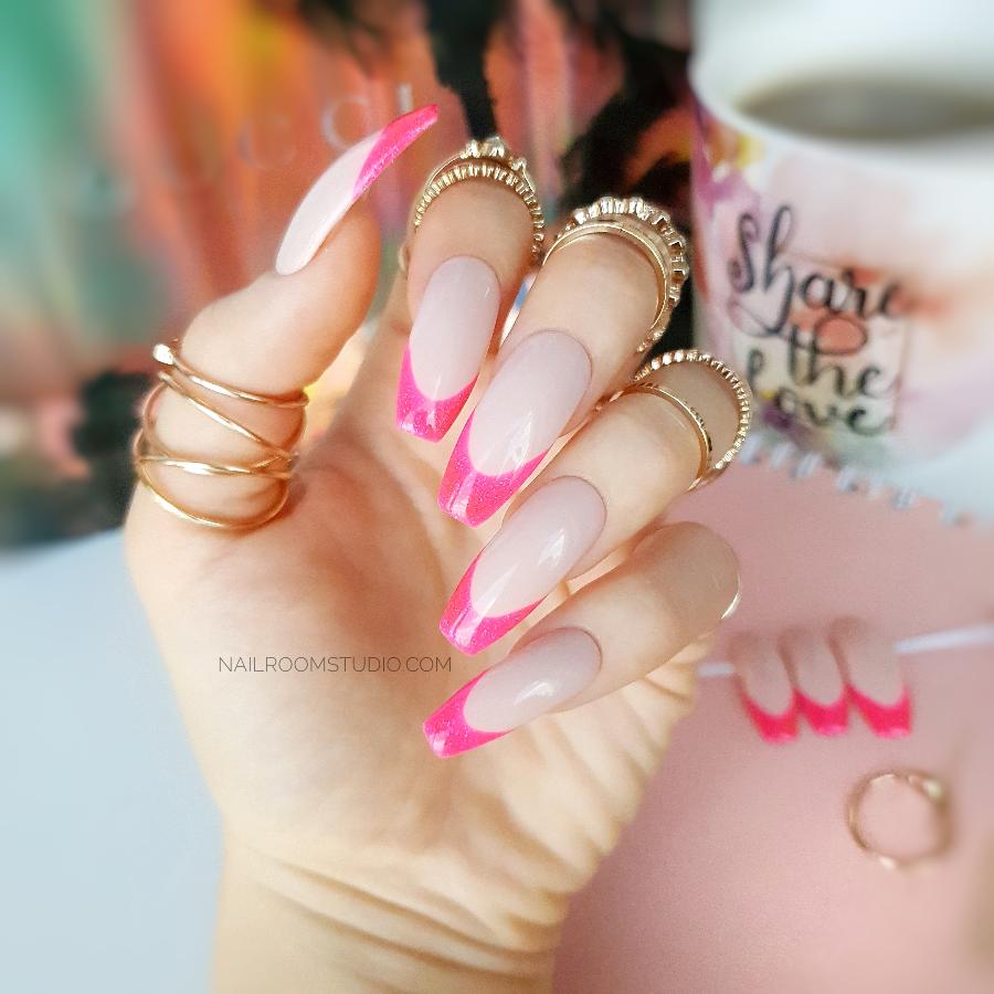 Classic French nails with a pink glittery finish and an intense pink French tip for a charming look