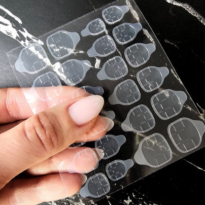 Pop-On Nail adhesive tabs that offer a seamless way to apply and remove artificial nails, ideal for temporary styles and easy changes