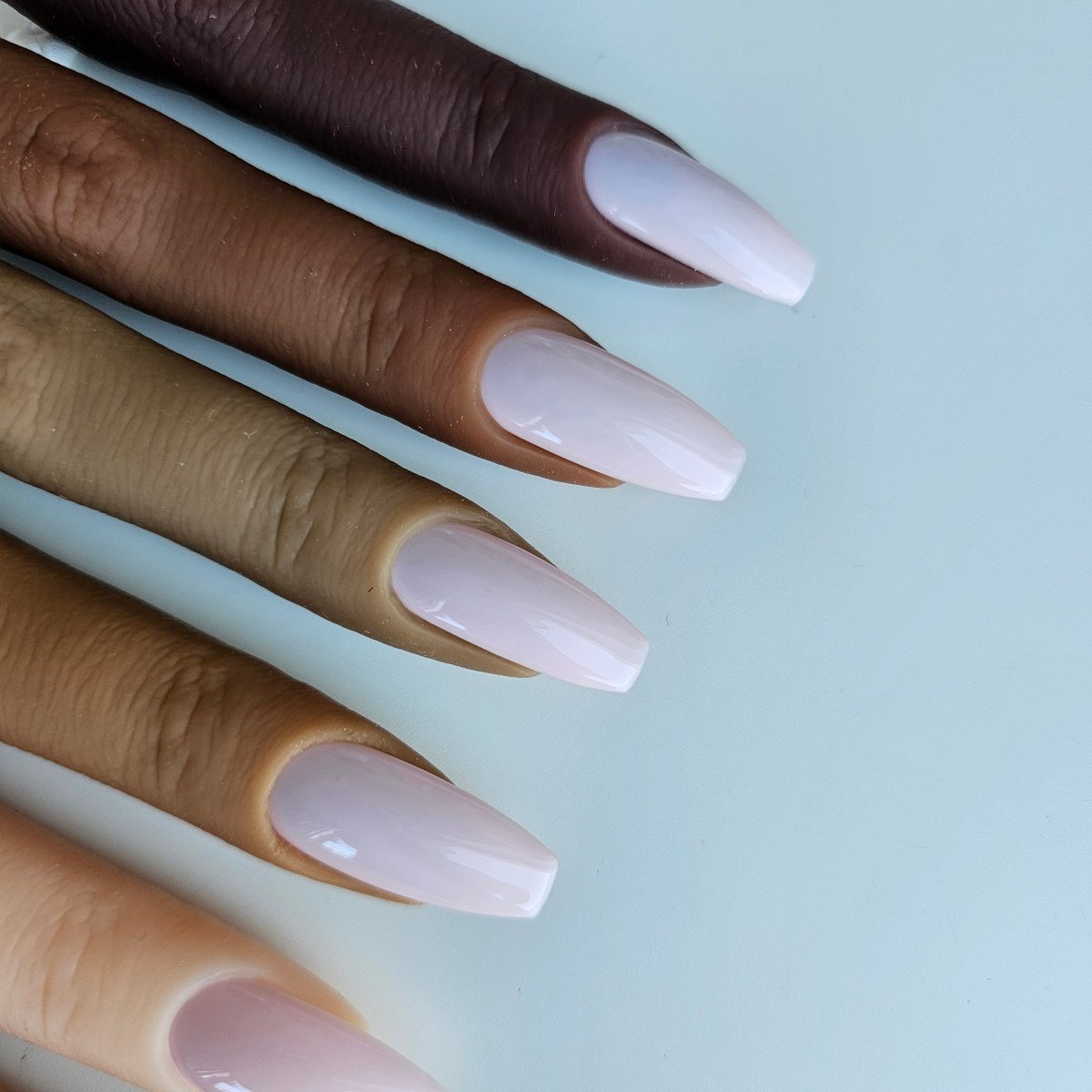 Powder pink press-on nails in a soft, delicate shade, highly opaque and solid color, with high-quality coverage for an elegant and refined look