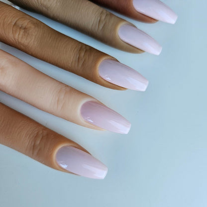 Powder pink press-on nails in a soft, delicate shade, highly opaque and solid color, with high-quality coverage for an elegant and refined look