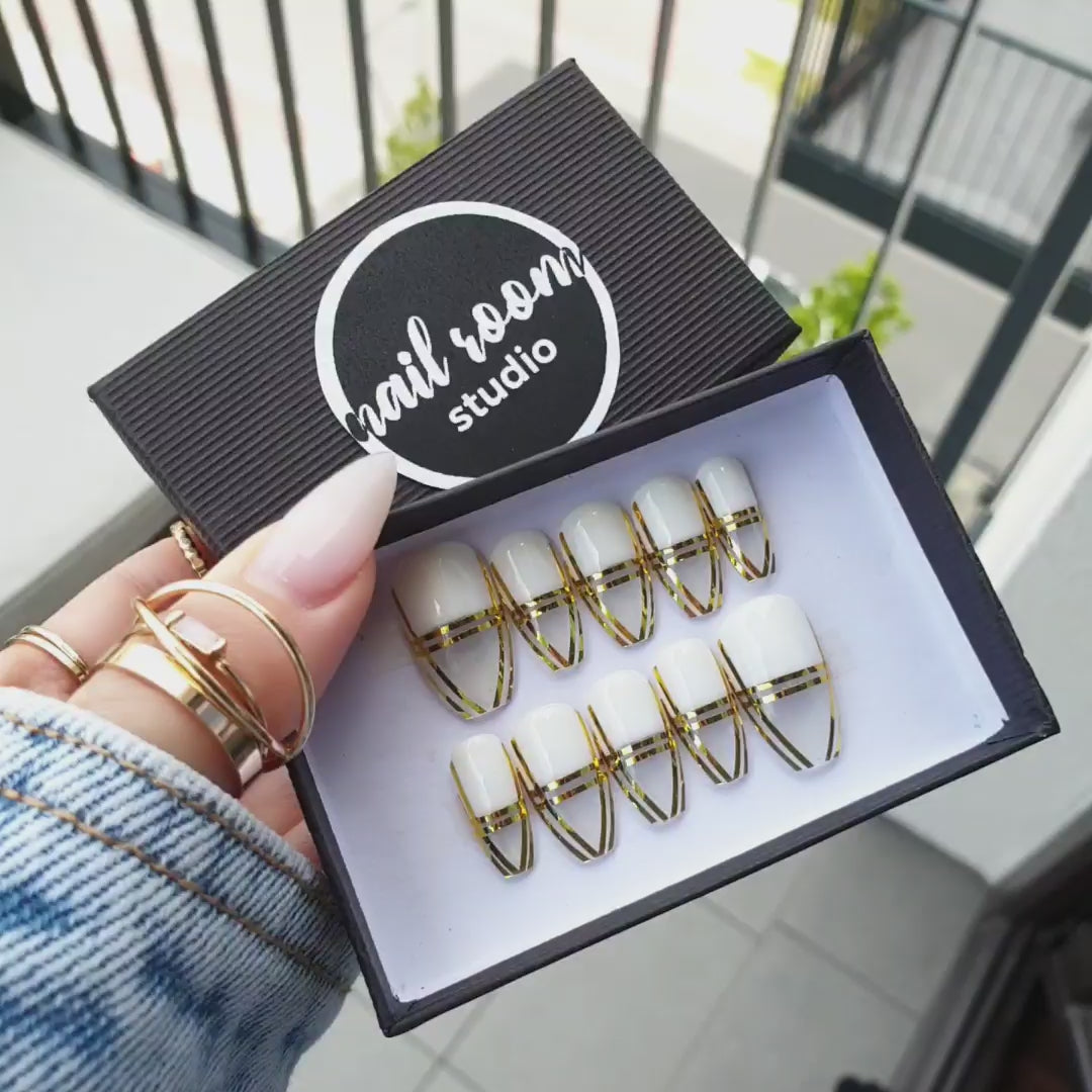 Sophisticated transparent coffin nails featuring elegant gold-framed French tips for a stylish and refined look by Nail Room Studio