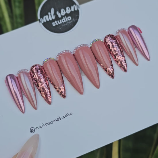 Stunning Shimmer press on nails in shades of pink champagne, gold, and nude, featuring intricate details like crystals and glitter for a glamorous finish