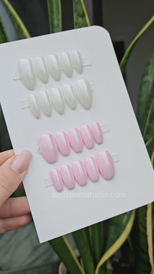 Stunning multi-colored press-on nails from the shimmer collection, featuring shades of peach, blue, lilac, pink, and green, ready for shipping