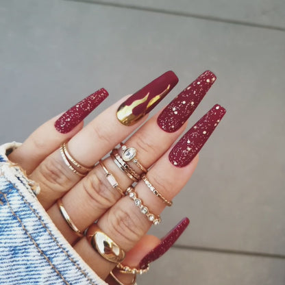 Ultraexclusive coffin burgundy matte nails in long sculpted coffin shape with matte glitter and gold chrome flames, bold and sophisticated, available in custom shapes and lengths, with feet reusable nails included by Nail Room Studio