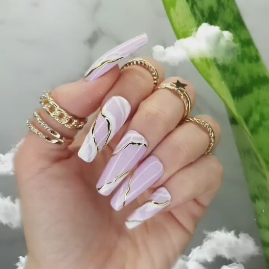 Long sculpted coffin press-on nails featuring soft pink and white waves with a glossy finish, hand-painted white marble design, and golden marble accents, perfect for both manicure and pedicure