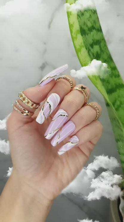 Long sculpted coffin press-on nails featuring soft pink and white waves with a glossy finish, hand-painted white marble design, and golden marble accents, perfect for both manicure and pedicure