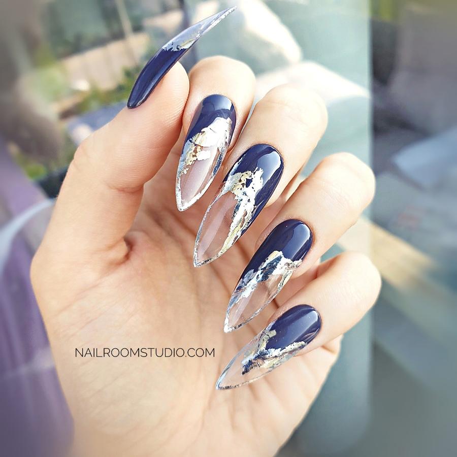 Deep plum purple press-on nails with unique French tips, featuring a silver chrome molten lava design, creating an original and standout look, displayed on hands