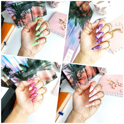 Nails with a marble and smoke effect in red, purple, nude, and green shades, creating a stunning watercolor-inspired design