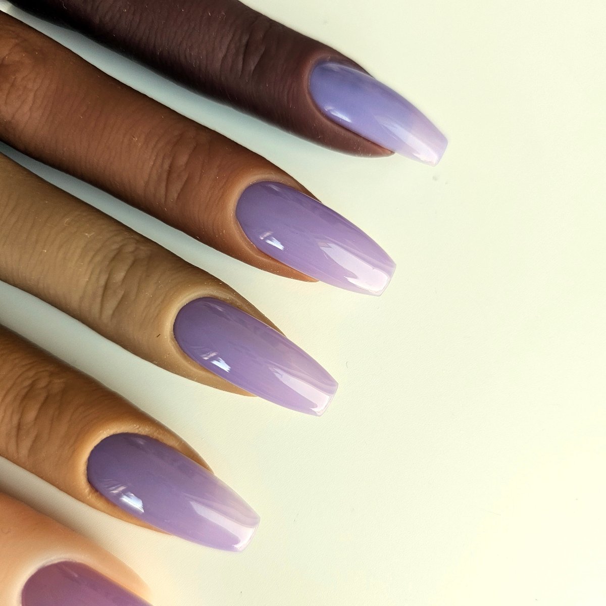 Partially transparent, soft purple faux nails with an airy, stylish appeal, ideal for a unique everyday look