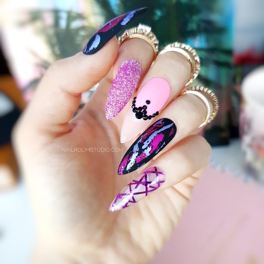 Vibrant pink and purple long stiletto nails with a chrome effect creating a bold and eye-catching look